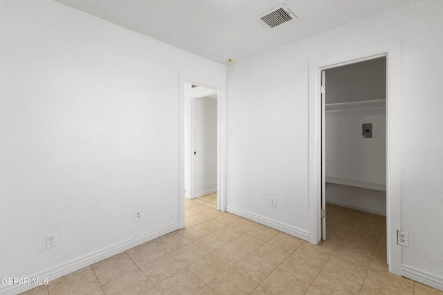 unfurnished bedroom with a walk in closet and a closet