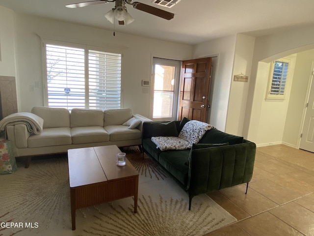 living room with ceiling fan and light tile patterned flooring