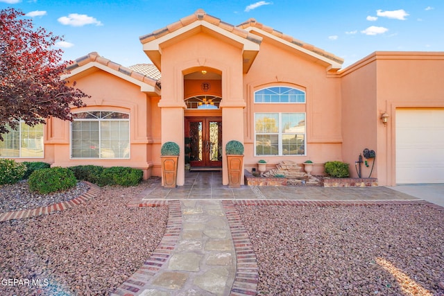 property entrance featuring french doors and a garage