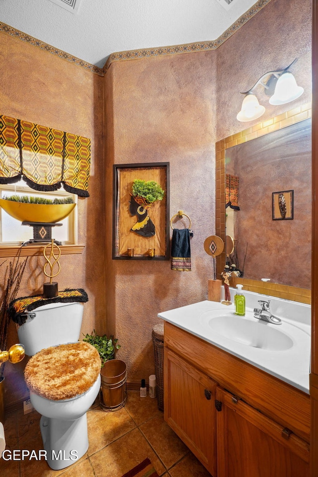 bathroom featuring tile patterned floors, toilet, and vanity