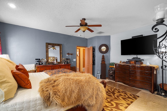 bedroom featuring a textured ceiling and ceiling fan