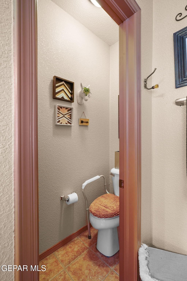 bathroom featuring toilet and tile patterned floors