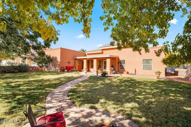 rear view of house with a yard