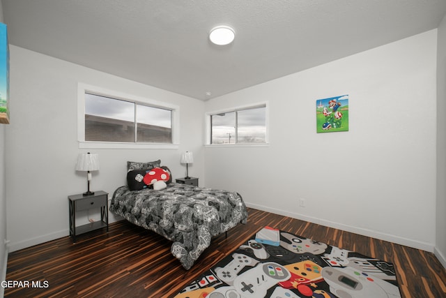 bedroom featuring lofted ceiling and dark wood-type flooring