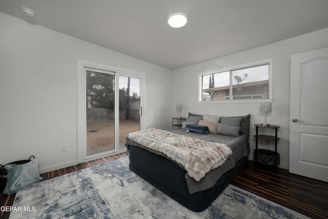 bedroom featuring dark wood-type flooring and access to exterior