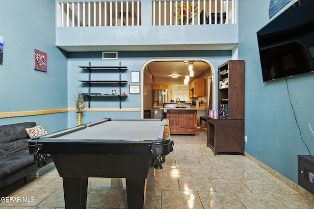 recreation room featuring a high ceiling and billiards