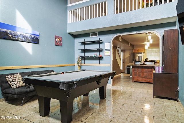 recreation room featuring pool table and a high ceiling