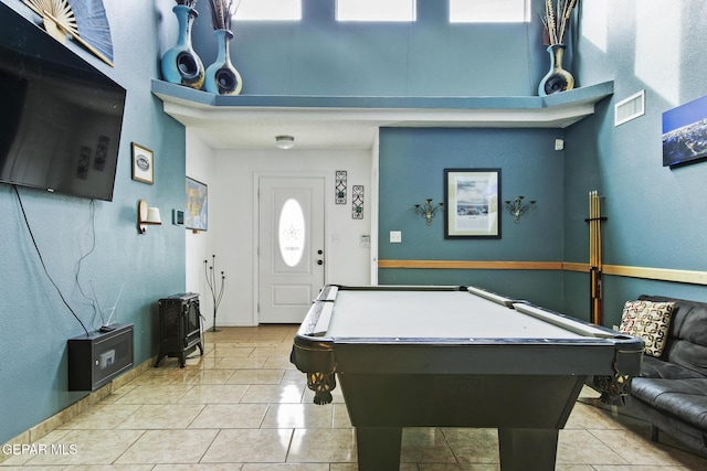 playroom with light tile patterned flooring, a towering ceiling, and billiards