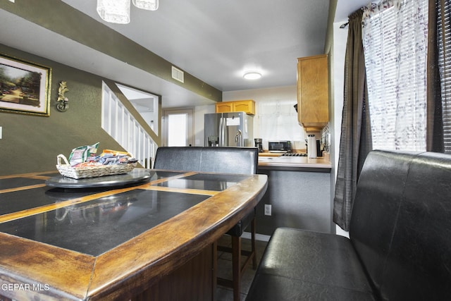 kitchen with stainless steel refrigerator with ice dispenser