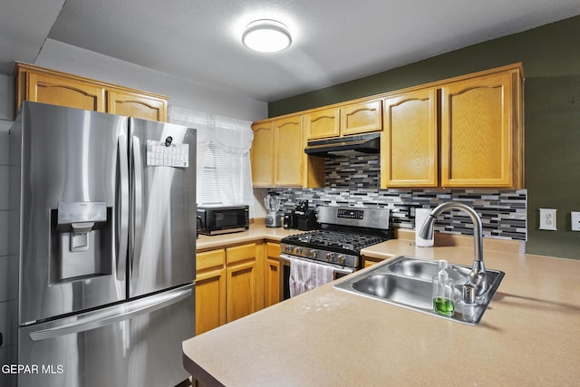 kitchen featuring backsplash, sink, and appliances with stainless steel finishes