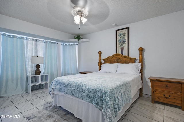 bedroom featuring a textured ceiling and ceiling fan