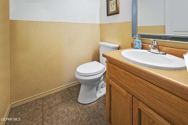 bathroom with tile patterned flooring, vanity, and toilet