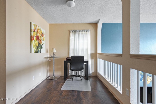 office space with dark hardwood / wood-style flooring, a textured ceiling, and a wealth of natural light