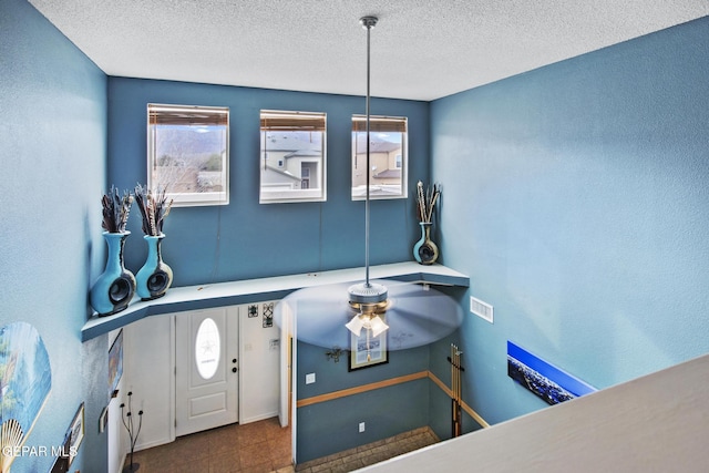 entryway with a textured ceiling