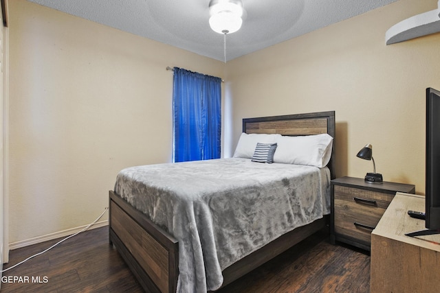 bedroom featuring ceiling fan and dark hardwood / wood-style floors