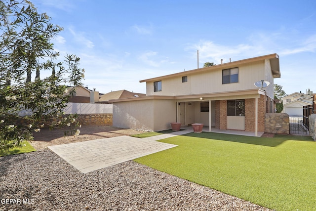 back of property featuring a yard and a patio