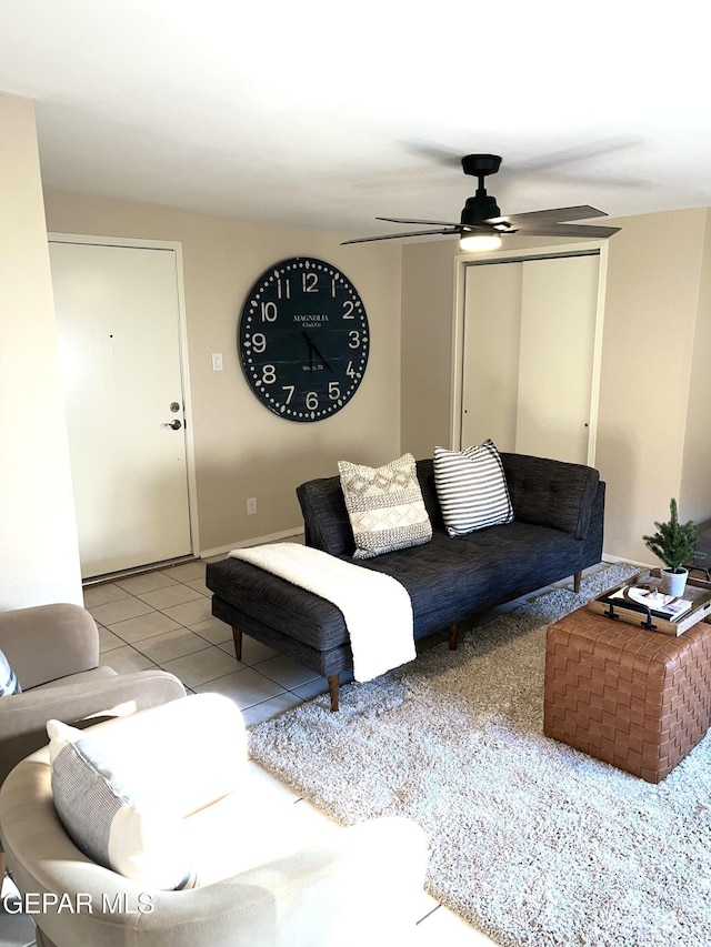 tiled living room featuring ceiling fan