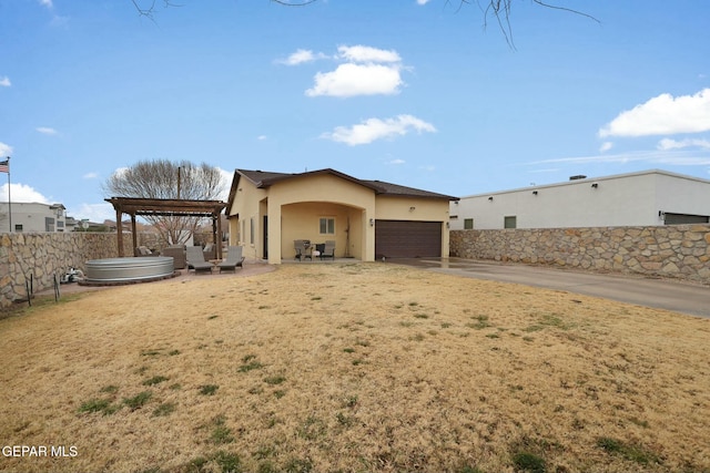 view of property exterior featuring a jacuzzi, a garage, and a lawn