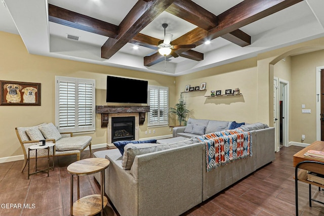 living room featuring ceiling fan and coffered ceiling