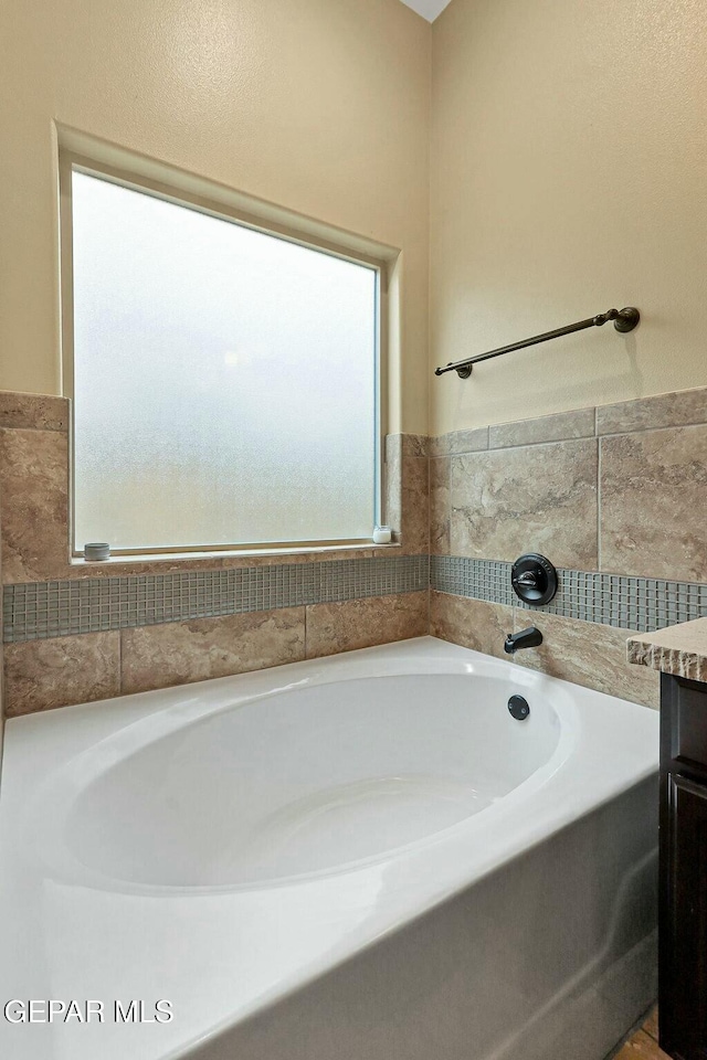 bathroom featuring a tub and vanity