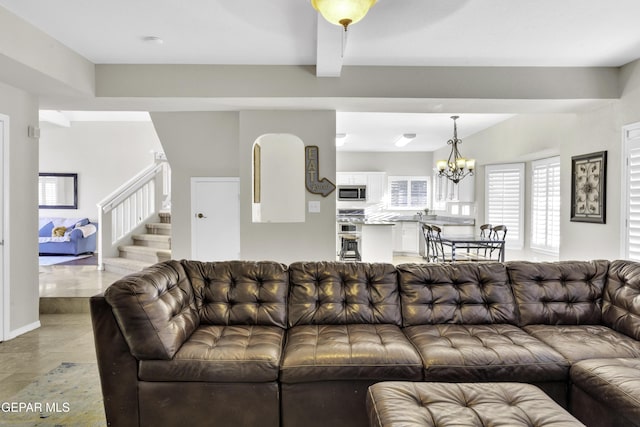 living room with beamed ceiling and a chandelier