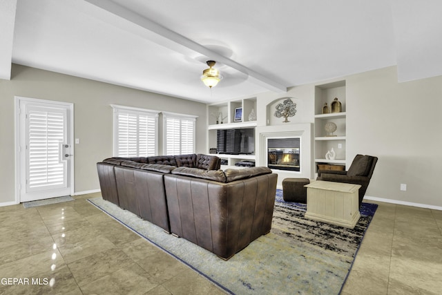 living room featuring beam ceiling, built in features, and ceiling fan