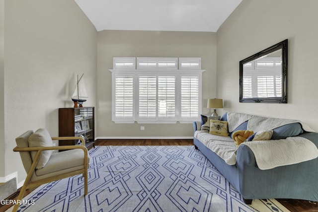 living room with hardwood / wood-style floors, a healthy amount of sunlight, and vaulted ceiling