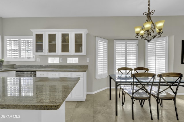 tiled dining space featuring an inviting chandelier