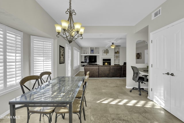 dining area with built in features and ceiling fan with notable chandelier