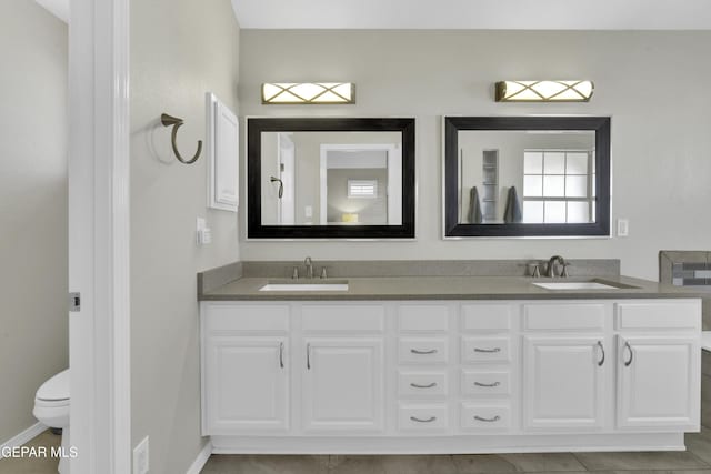 bathroom with tile patterned floors, vanity, and toilet