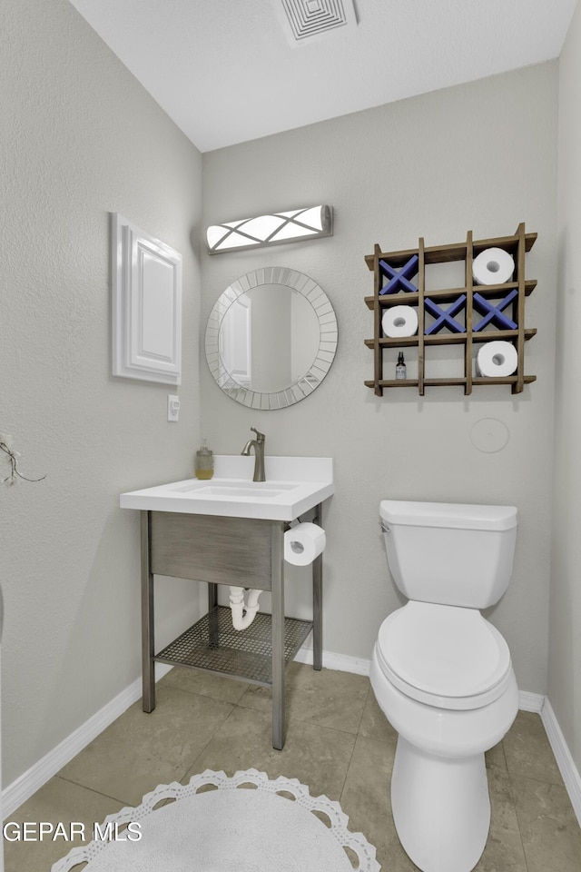 bathroom featuring toilet and tile patterned floors