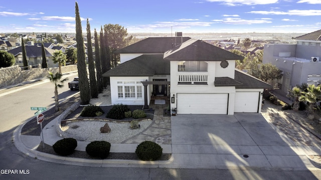 view of front of property featuring a balcony and a garage