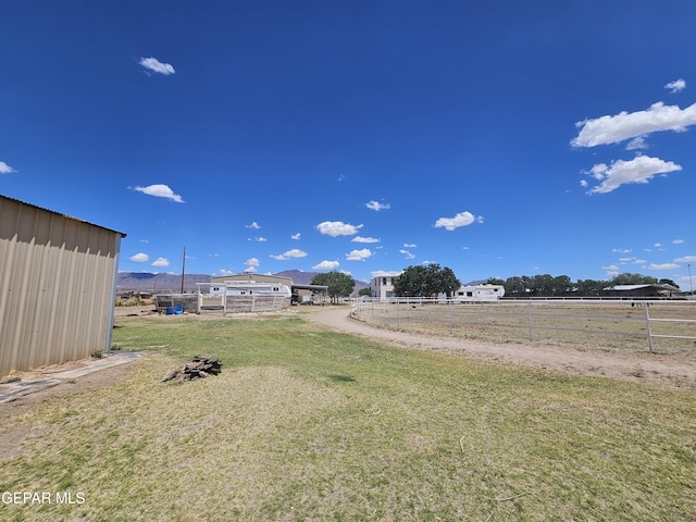 view of yard with a rural view