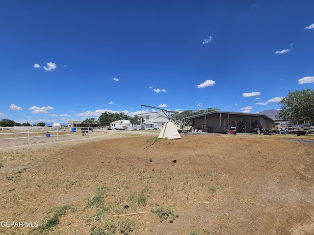 view of yard with a rural view