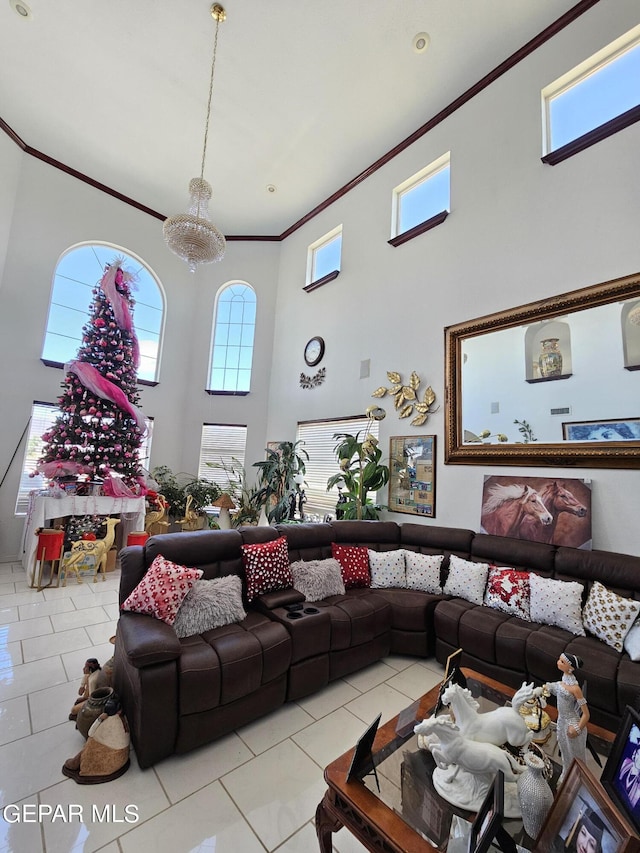 tiled living room with a towering ceiling, crown molding, and a notable chandelier