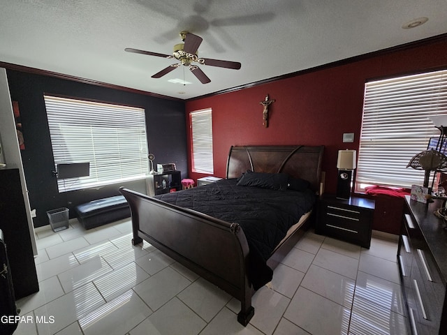 tiled bedroom featuring ceiling fan, crown molding, and a textured ceiling