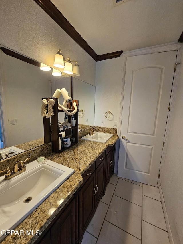 bathroom featuring crown molding, tile patterned flooring, and vanity