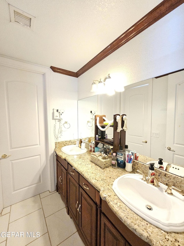 bathroom featuring vanity, tile patterned floors, and crown molding