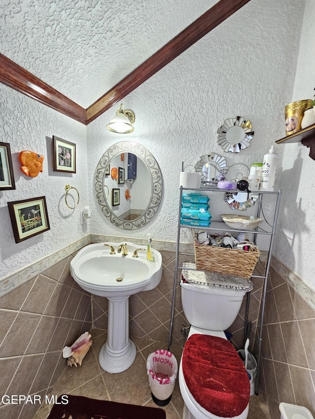 bathroom featuring tile walls and toilet