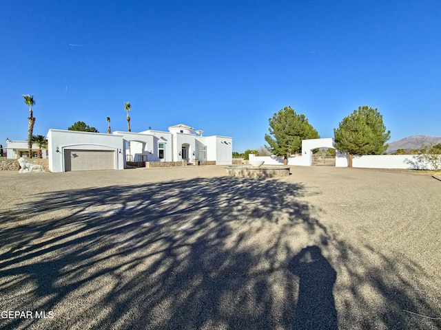 view of front of property with a mountain view and a garage