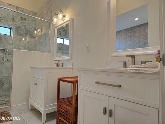 bathroom with tile patterned flooring, vanity, and walk in shower