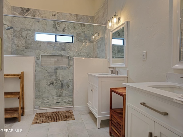 bathroom with tile patterned floors, vanity, and a shower with shower door