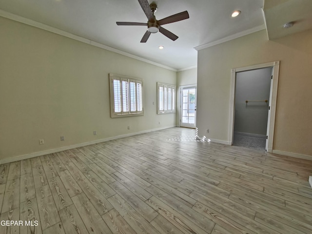 empty room with ceiling fan, light wood-type flooring, and crown molding