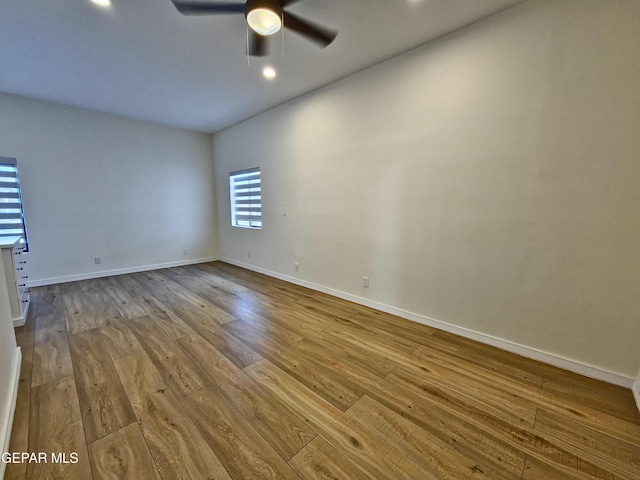 spare room with light wood-type flooring and ceiling fan