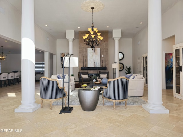 living room with a chandelier, a high ceiling, decorative columns, and crown molding