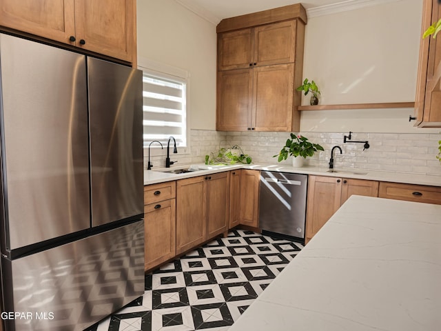 kitchen with decorative backsplash, sink, stainless steel appliances, and ornamental molding