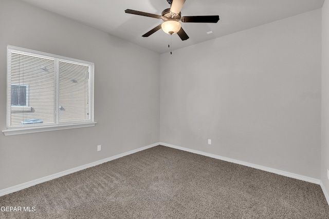 carpeted spare room featuring ceiling fan