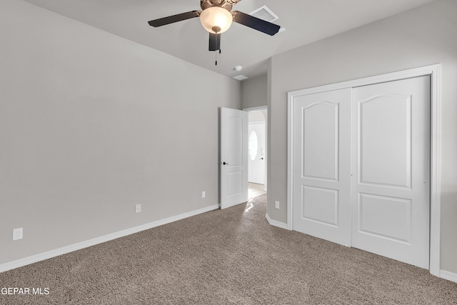 unfurnished bedroom with carpet floors, a closet, and ceiling fan