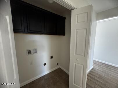 clothes washing area featuring hookup for an electric dryer, hookup for a washing machine, and hardwood / wood-style flooring