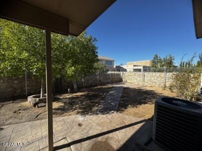 view of yard featuring cooling unit and a patio